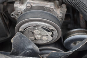Engine belt replacement service at Consolidated Truck Parts & Service. Image showing a worn and cracked engine belt.