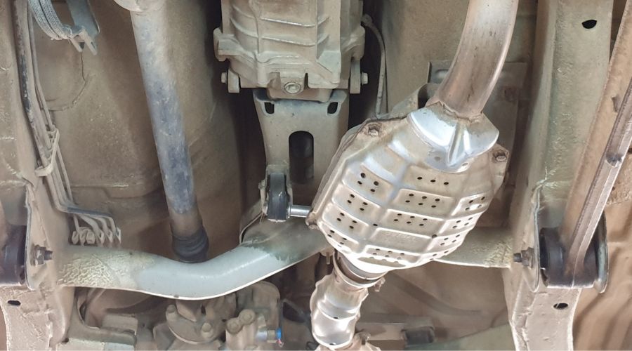 dpf service near me in Monroe, LA with Consolidated Truck Parts & Service. Image of A diesel particulate filter in the exhaust system in a truck on a lift in the auto shop