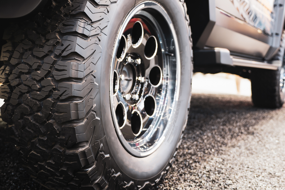 Tire maintenance for diesel trucks in hot weather at Consolidated Truck Parts & Service in Monroe, LA. Close-up image of a rugged off-road tire, highlighting the importance of regular inspections, maintaining proper tire pressure, and rotating tires to ensure safe driving conditions during the summer.