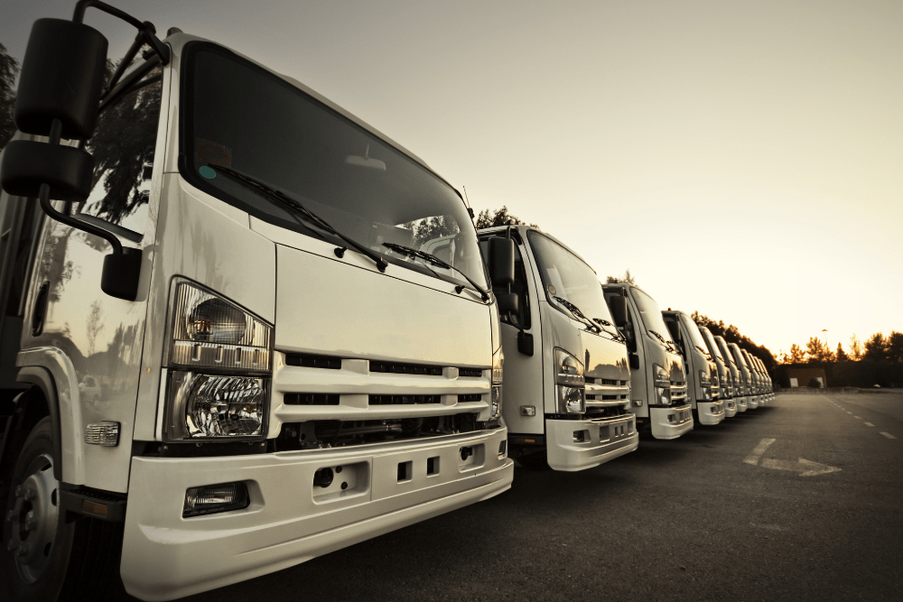 Allison Transmission Repair, truck repair in Many, LA at Consolidated Truck Parts & Service. Lineup of commercial trucks at sunset.