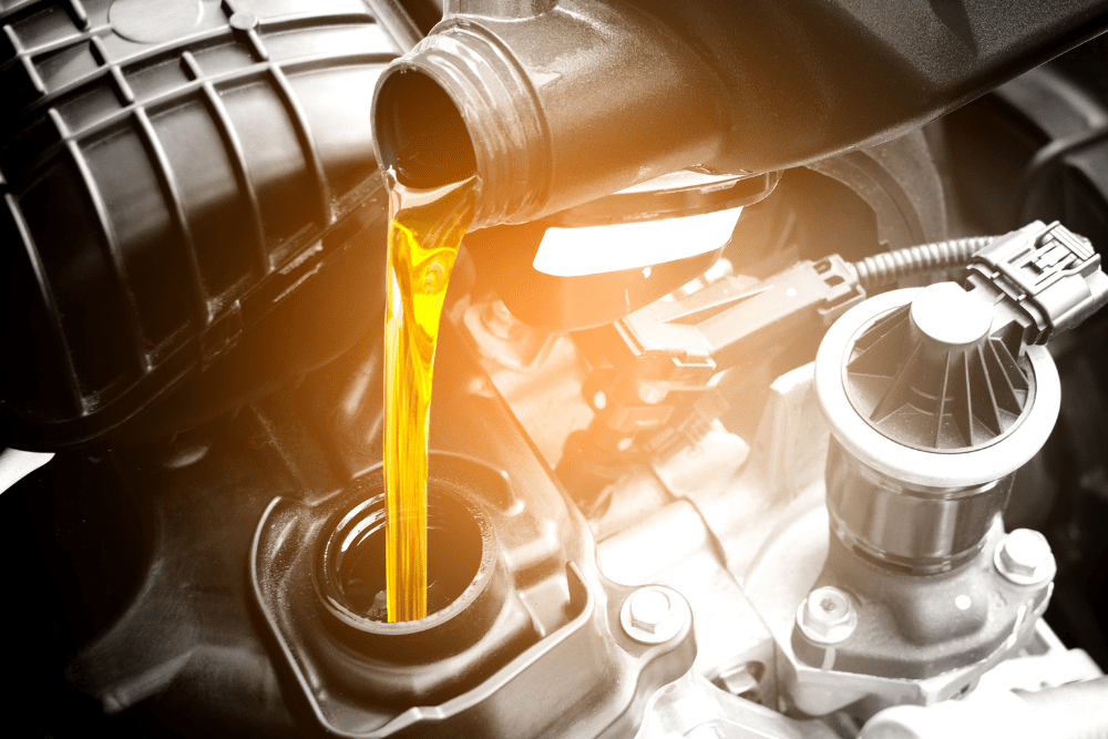 regular oil change, diesel repair in Lafayette, LA at Consolidated Truck Parts & Service. Close-up of fresh motor oil being poured into an engine.