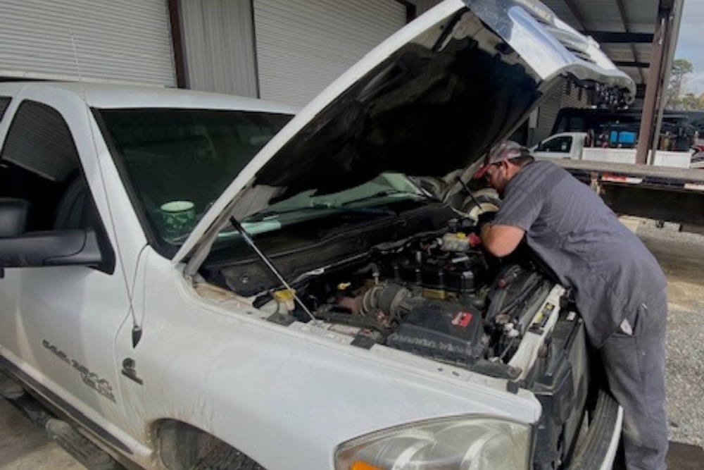 Diesel Truck Maintenance In Many LA At Consolidated Truck. Auto mechanic checking on diesel truck engine.