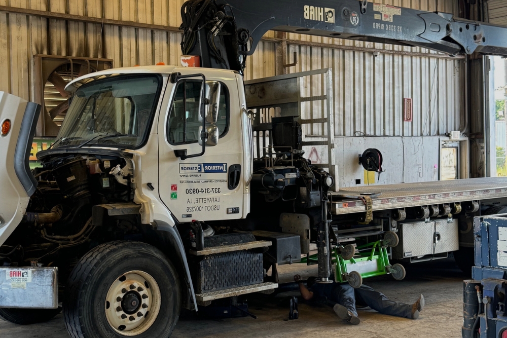 Pre-winter truck maintenance in Alexandria, LA by Consolidated Truck Parts & Service. Image of a technician inspecting a semi-truck in a service bay before winter.